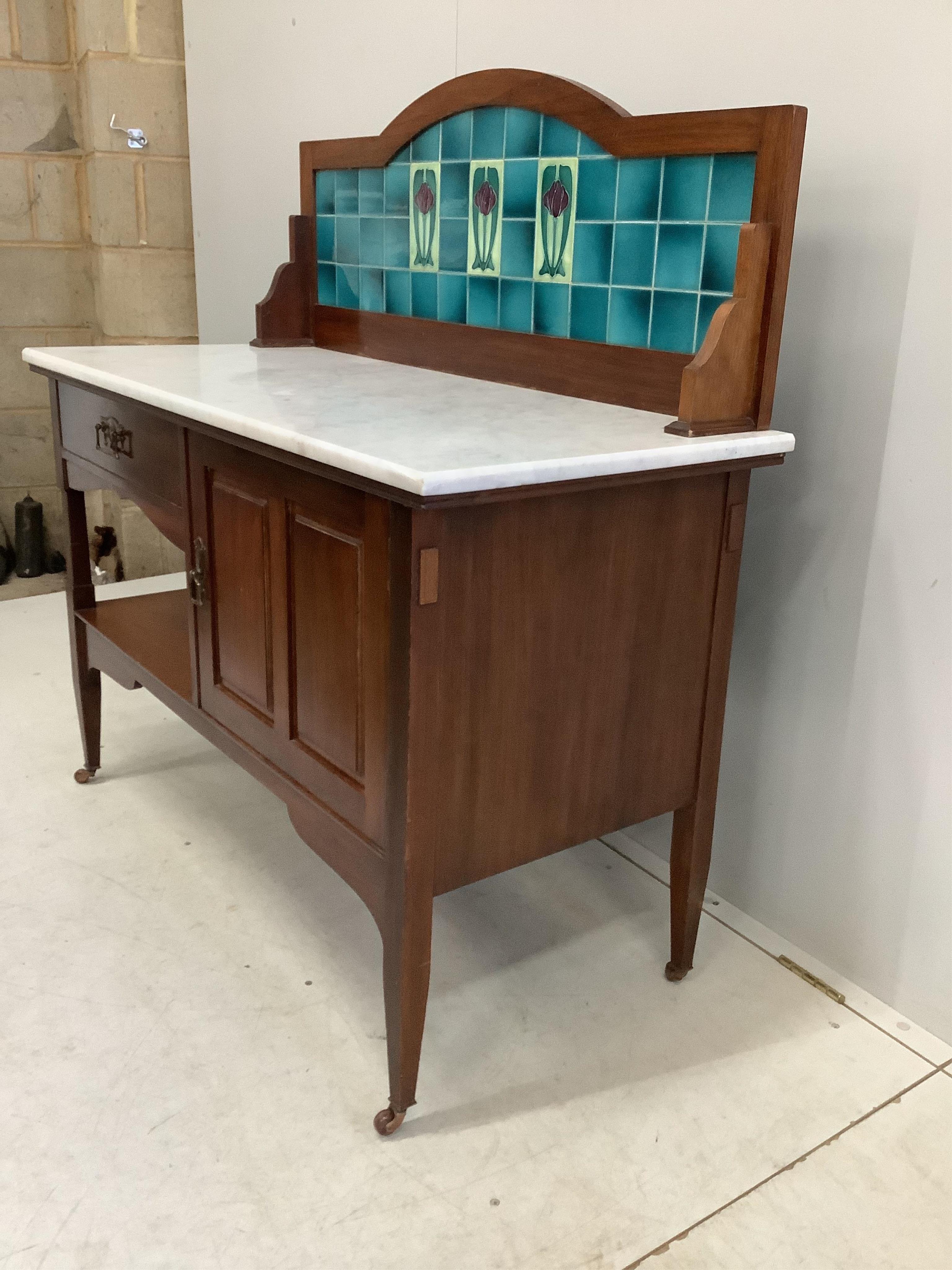 An Art Nouveau marble topped tile backed washstand, width 114cm, depth 51cm, height 118cm. Condition - good